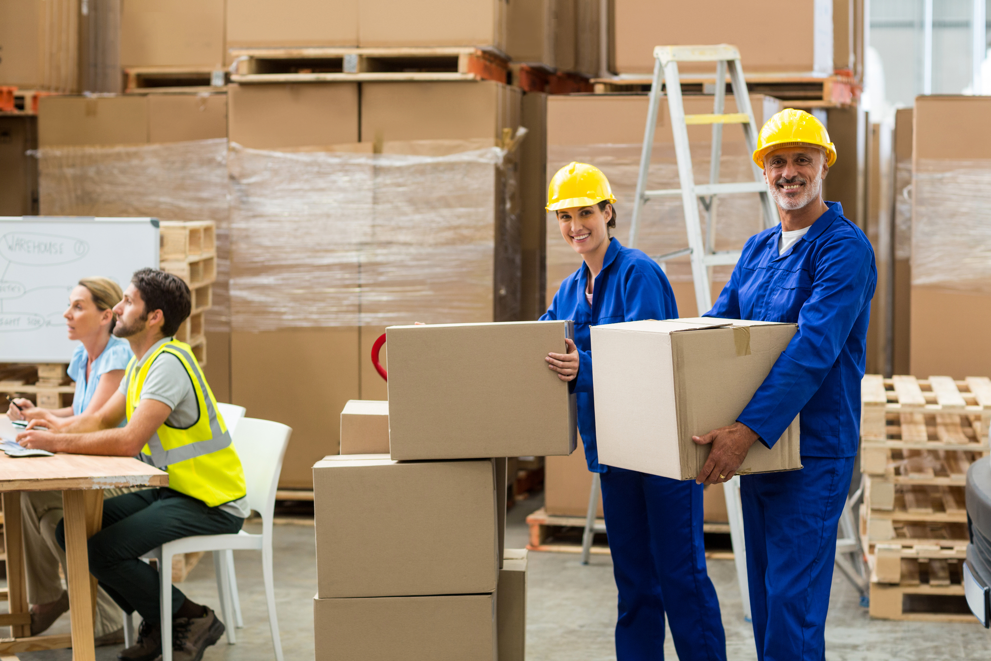 Smiling workers looking at camera in warehouse